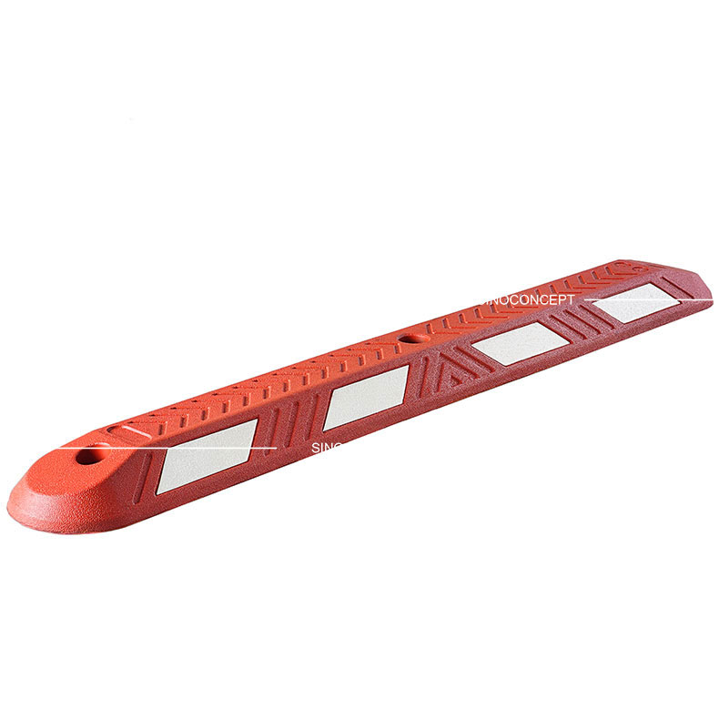 A red rubber lane divider with white reflective films used for traffic management.