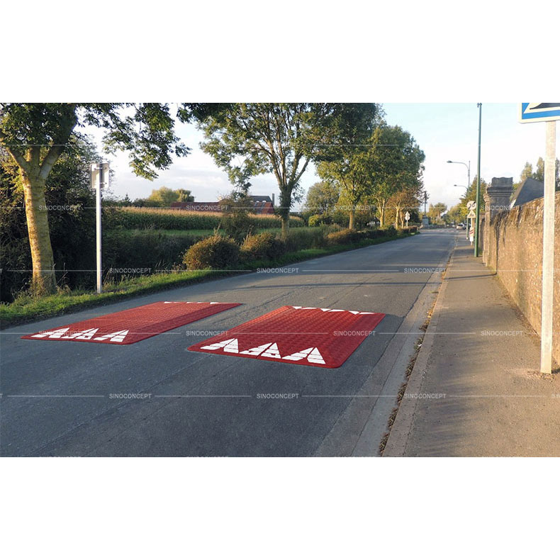 Red rubber road cushions also called speed cushions with white reflective tapes used on road for the traffic calming purpose in Europe