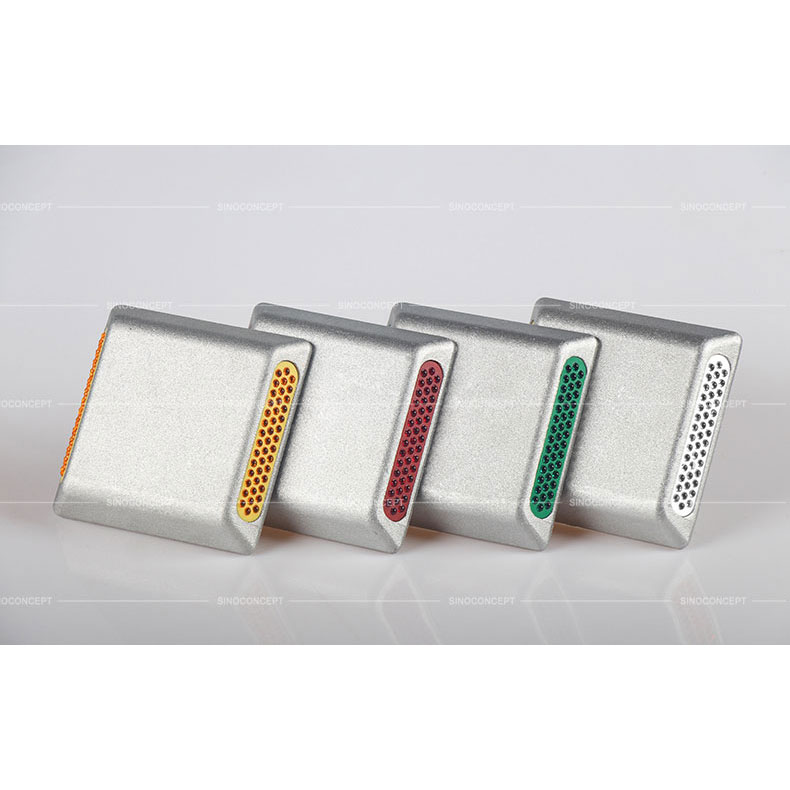 Four colours of aluminium road studs also called aluminium road reflectors used as traffic safety devices