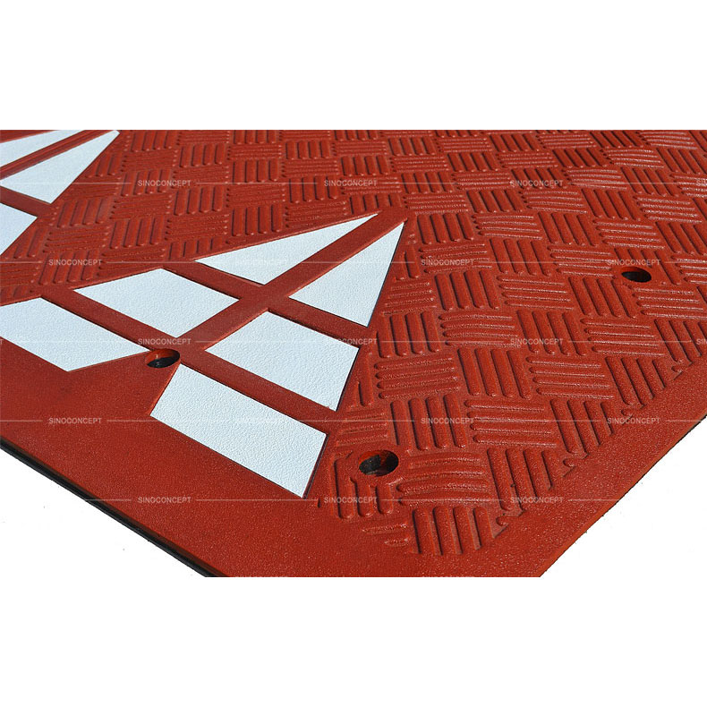 Red speed table with anti-slipe stripes design on the surface and white glass bead reflective tapes used as traffic calming devices