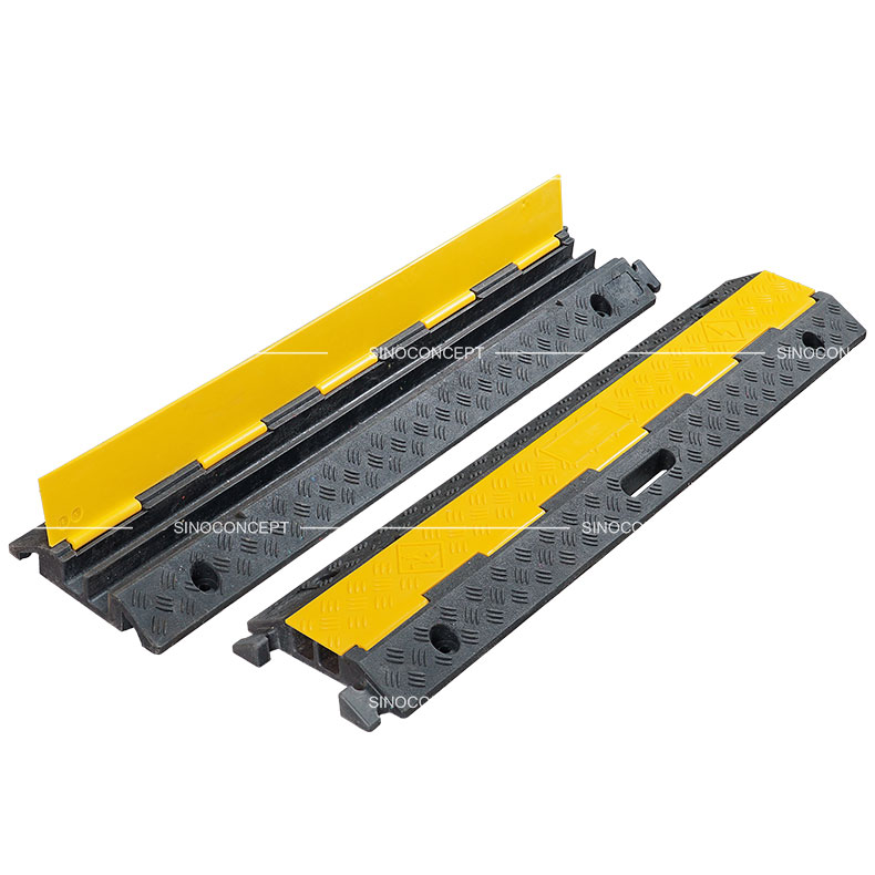 Two channels cable ramps made of rubber also called floor cable covers designed with anti-slip surface and yellow plastic covers.