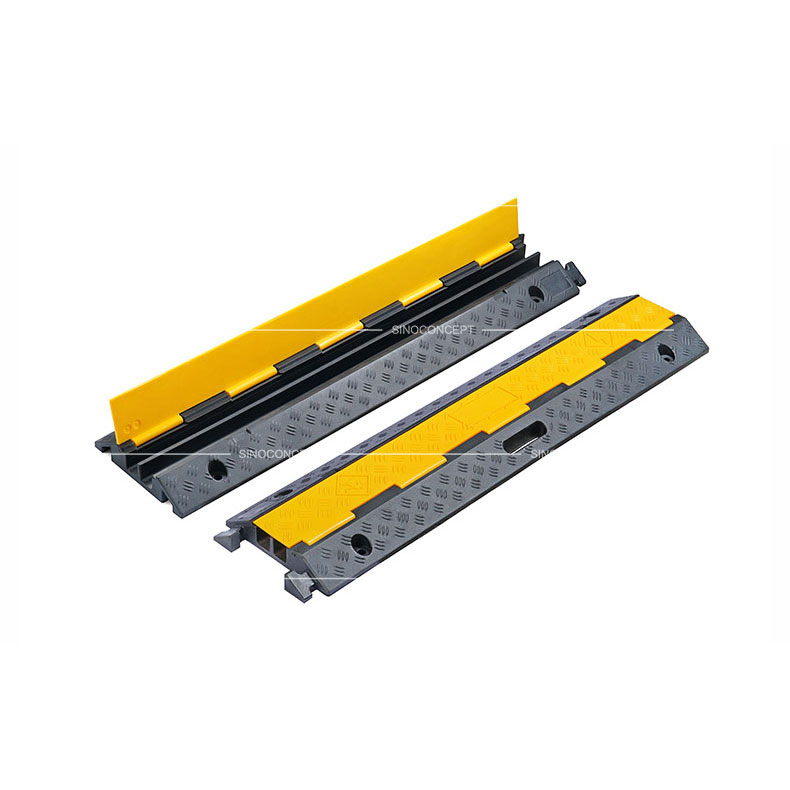 Two channels cable ramps made of rubber also called floor cable covers designed with anti-slip surface and yellow plastic covers.