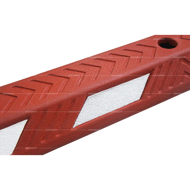 Red rubber cycle lane separator also called cycle lane divider made of vulcanized rubber showing rubber arrows design on the surface