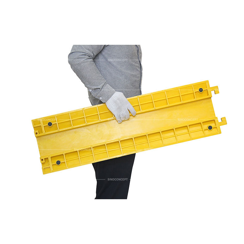 Polyurethane drop over cable protector of yellow colour designed with convenient handles for easy movement and black anti-slip pads
