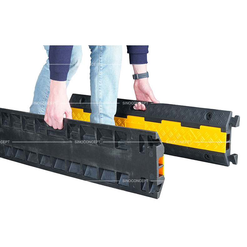 A two-channel rubber cable ramps also called two channels cable ramps designed with convenient handles for easy movement.