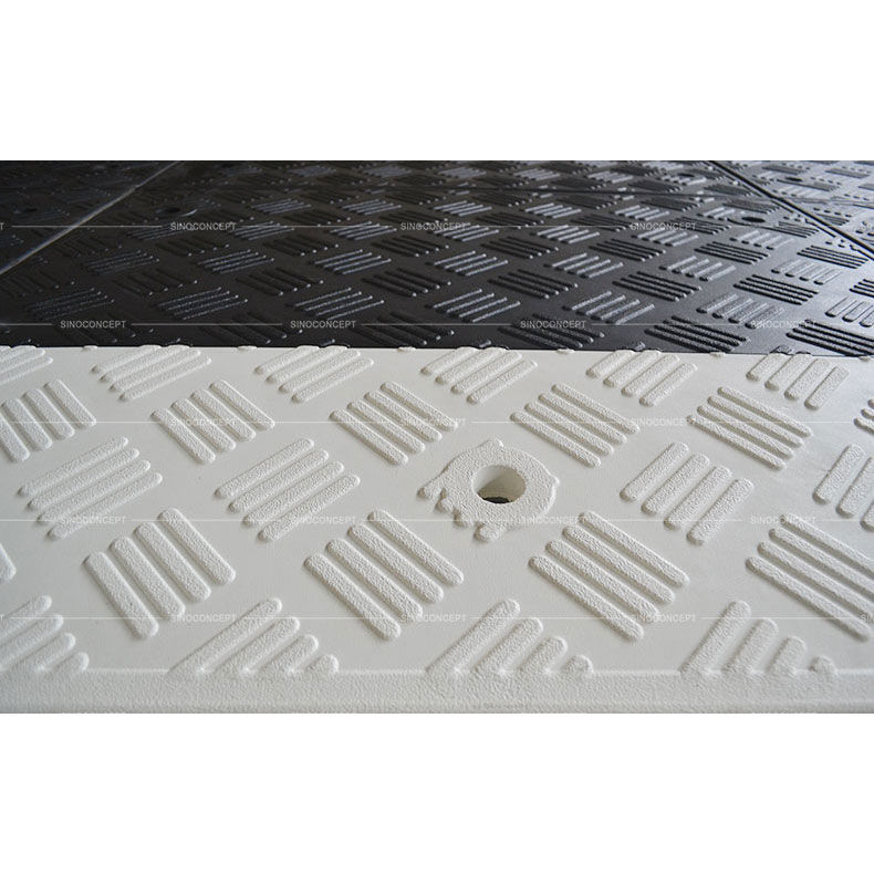 Black rubber speed cushion with anti-slipe stripes design on the surface used as traffic calming devices