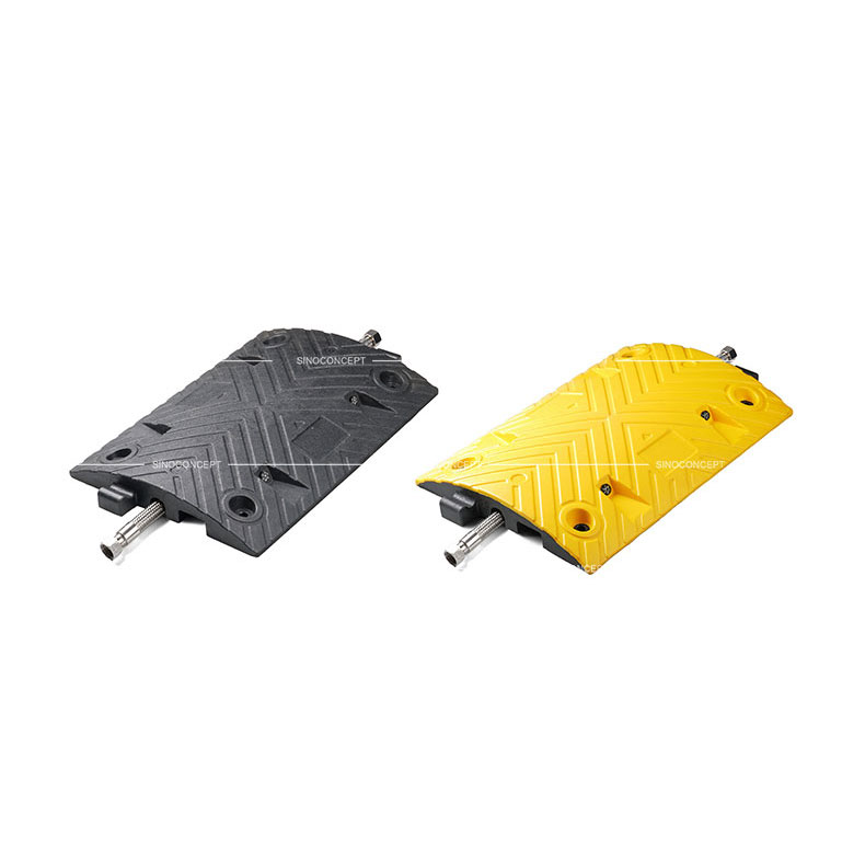 A black and a yellow middle parts of a 5cm high Plastic-Rubber composite speed bump designed with a channel to receive one cable.