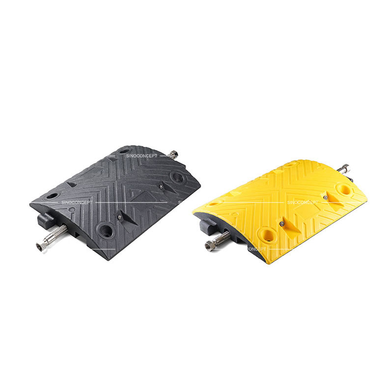 A black and a yellow middle parts of a 7cm high Plastic-Rubber composite speed bump designed with a channel to receive one cable.